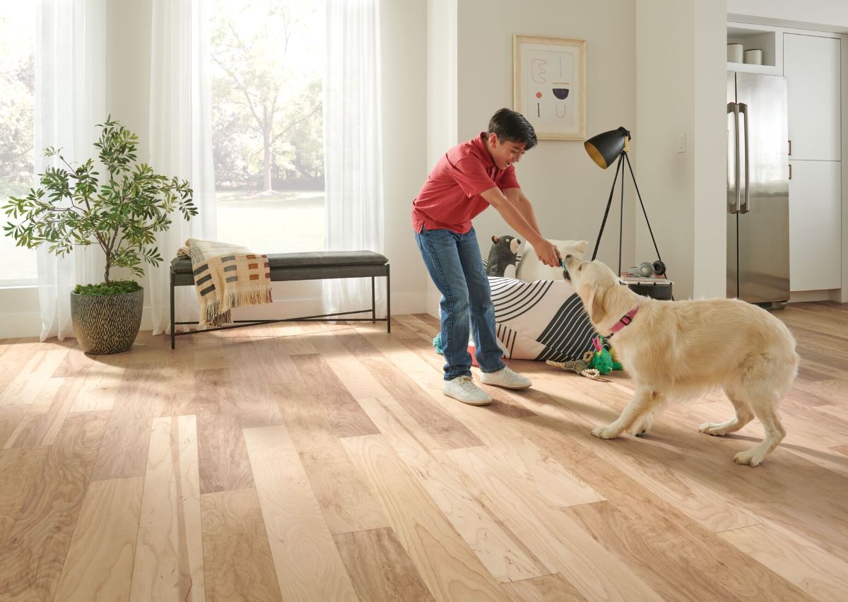 Child playing with a dog on a Dogwood Pro densified wood floor