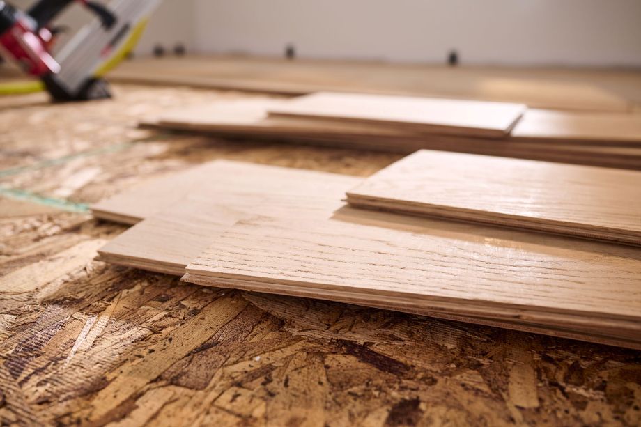 Unfinished wood flooring sitting on a pile to acclimate before installation