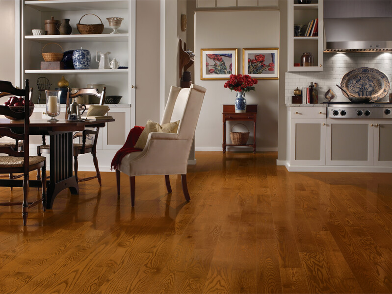 Dining room off the kitchen with a table and chairs and red oak flooring