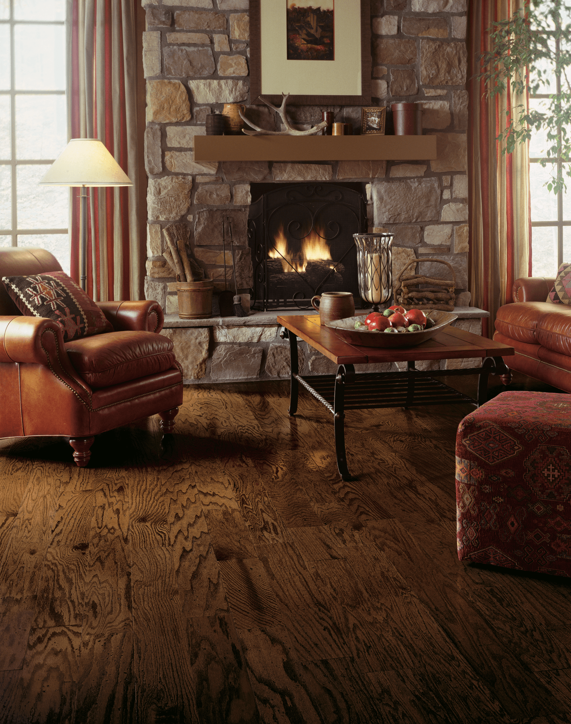 American Originals Red Oak Engineered - Durango Den with a fireplace and seating showing red oak engineered hardwood flooring from Bruce
